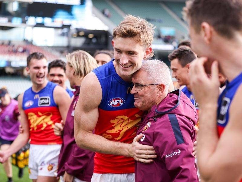 Brisbane's Harris Andrews (centre) hugs his coach Chris Fagan after his 200th AFL game. (Matt Turner/AAP PHOTOS)