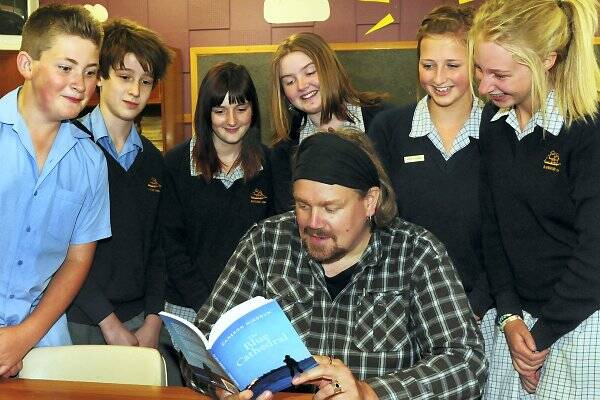 Writer and poet Cameron Hindrum shows his first book, The Blue Cathedral, to Riverside High students Jack Keenan, Darcy O'Malley, Taniesha Cane-Wickham, Monique Bott, Sophie Bodell and Maggie Gilligan.