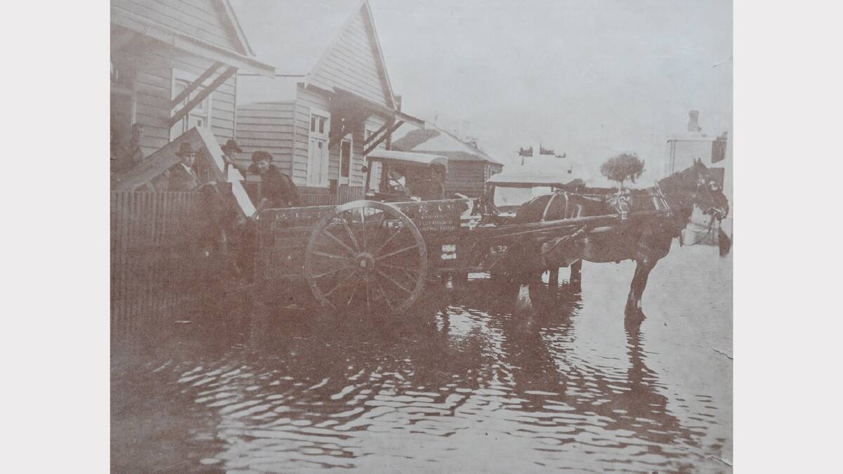 1929 Floods: F. H. Stephens Pty Ltd Rescue Party salvaging a player-piano from a flooded home in Bedford Street, Inveresk. The Weekly Courier, April 17, 1929.