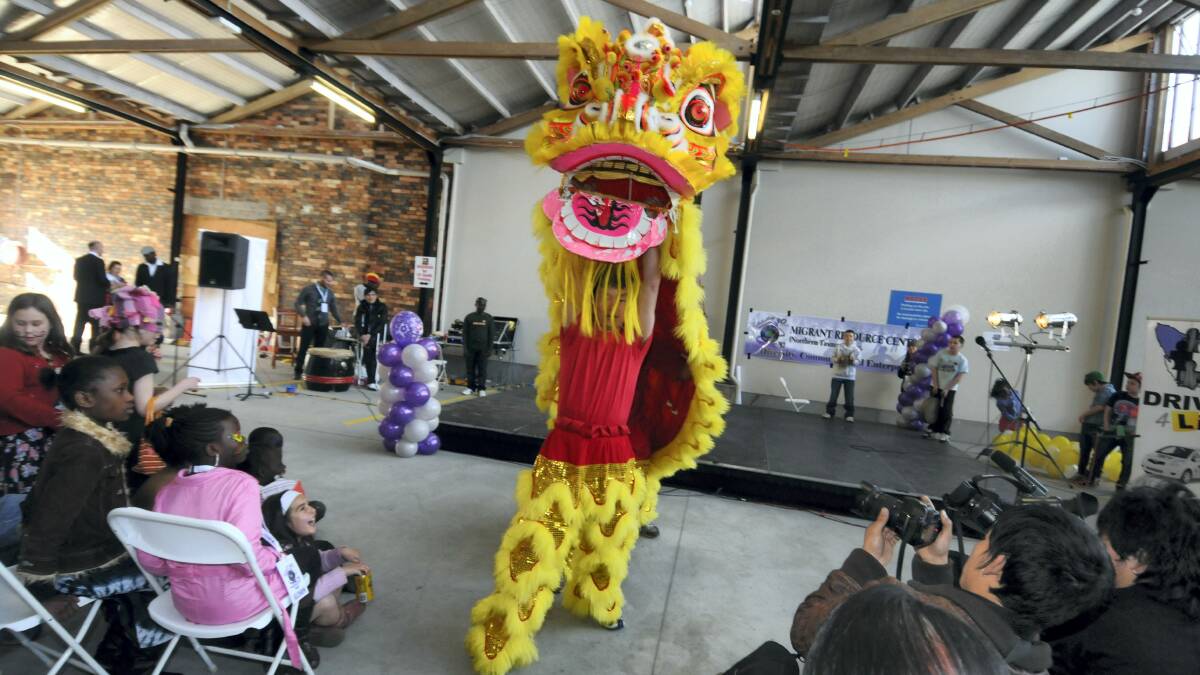 Dragon operators Wei-Siong Liang and Michael Beams entertain the crowd at yesterday's Northern Tasmanian Migrant Resource Centre's 30th anniversary celebrations. Picture: GEOFF ROBSON